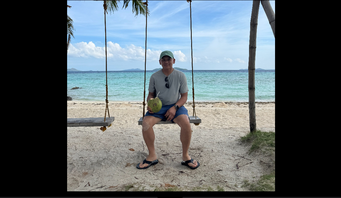 Dr. Tony Hoang standing under a nipa hut structure